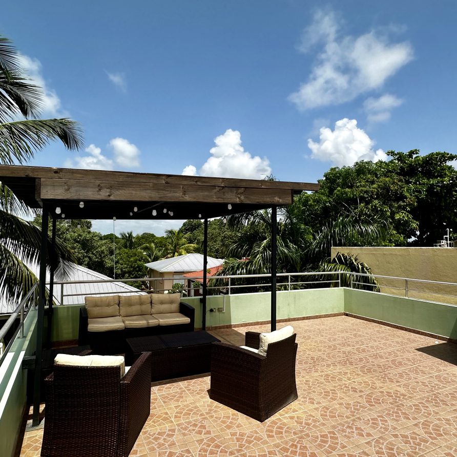 MeMe's Place Estate rooftop pergola lounge with sectional sofas