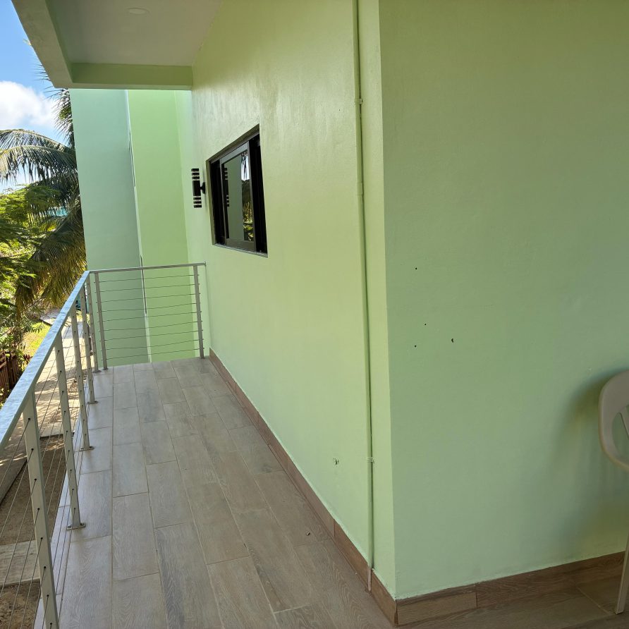 Honeycreeper Suite balcony with chair overlooking garden