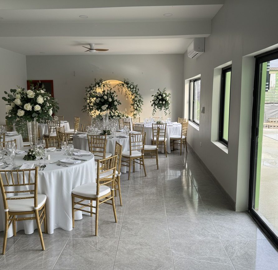 MeMe's Place event hall set up for a wedding reception with white tablecloths and floral centerpieces