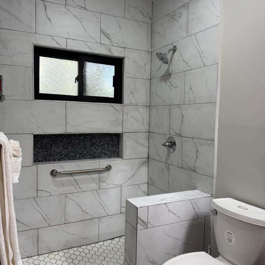 Toucan Room marble shower with built-in tile niche