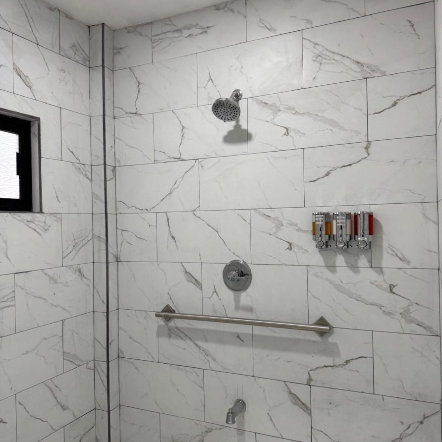 MeMe's Place Estate marble shower with chrome fixtures