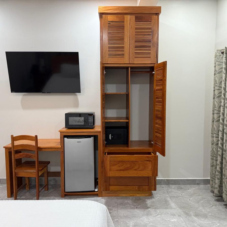 Toucan Room desk with safe inside open wooden wardrobe
