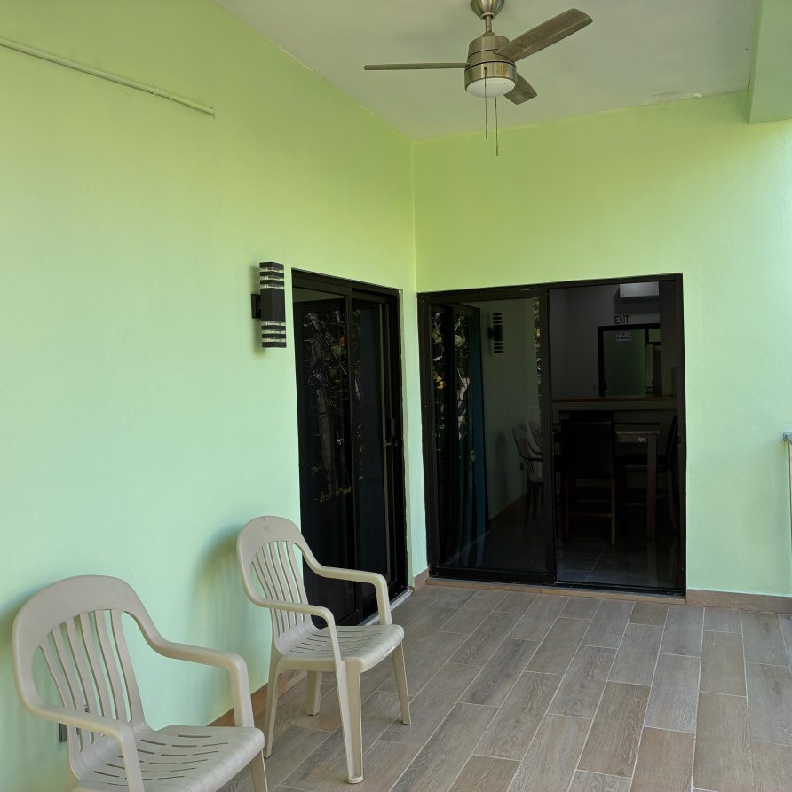 Honeycreeper Suite covered patio with chairs and ceiling fan